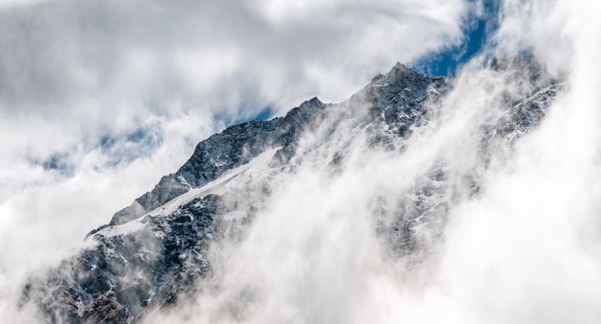 Cloud breaking over a ridgeline
